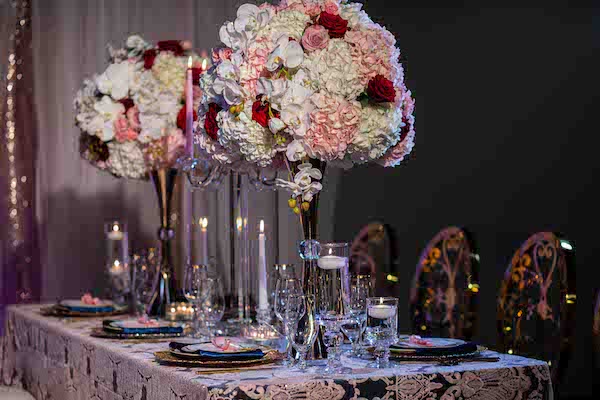 long wedding reception tables with embroidered line and tall blush and burgundy centerpieces